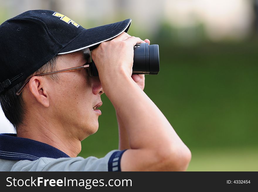 Chinese Man Looking Through Binoculars