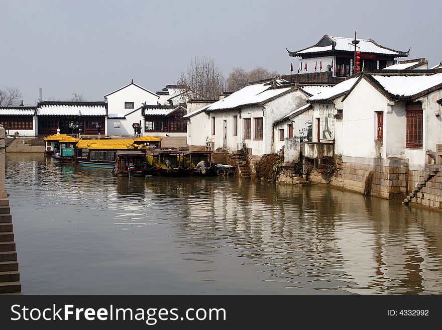 The beautiful and enjoyable snow scenery in the winter in the southern part of China. These sceneries are famous for their snow ,water, houses,and the blue sky.They are typical of the south in China.This picture is taken in the place of interest“Mooring by the Feng Bridge at night” in Suzhou ,China.