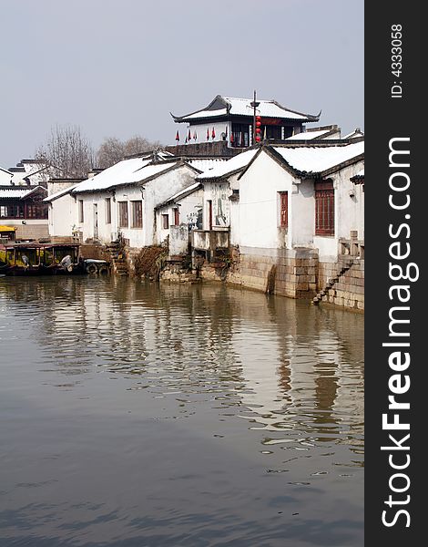 The beautiful and enjoyable snow scenery in the winter in the southern part of China. These sceneries are famous for their snow ,water, houses,and the blue sky.They are typical of the south in China.This picture is taken in the place of interestâ€œMooring by the Feng Bridge at nightâ€ in Suzhou ,China.
