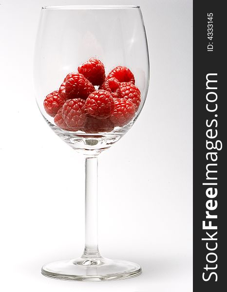 Raspberries on a transparent cup. Raspberries on a transparent cup