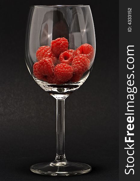 Raspberries on a transparent cup