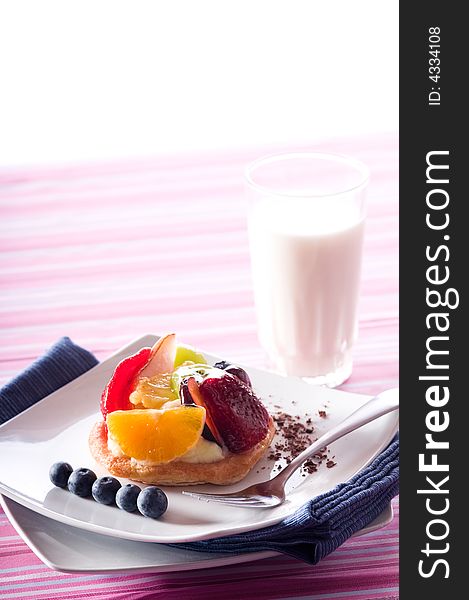 Fruit Tart on a white plate on a table