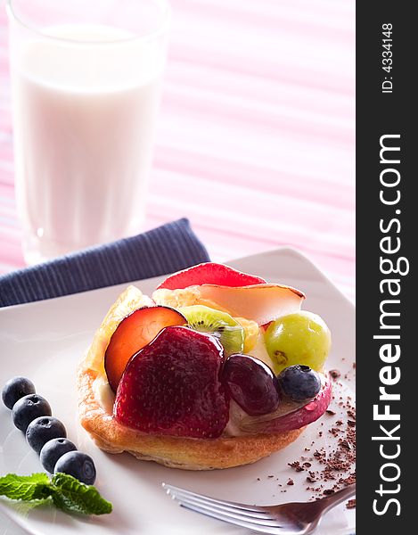 Fruit Tart on a white plate on a table