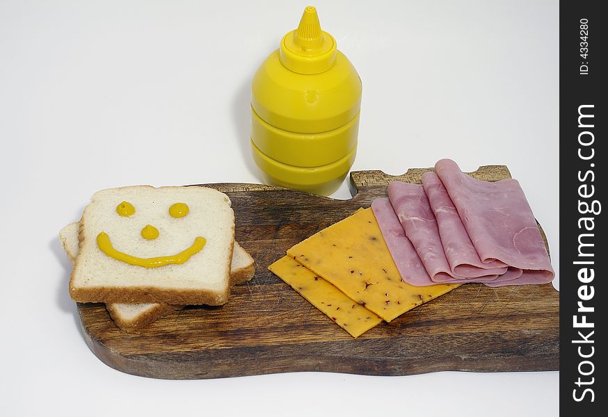 The makings of a hame and cheese
sandwich, with mustard. The makings of a hame and cheese
sandwich, with mustard.