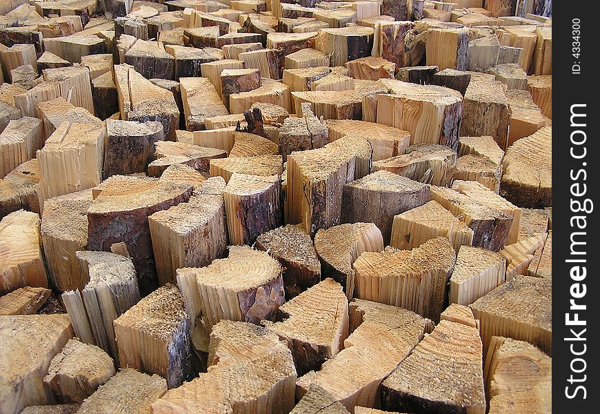 Lots of tree trunks in a wood warehouse. Lots of tree trunks in a wood warehouse
