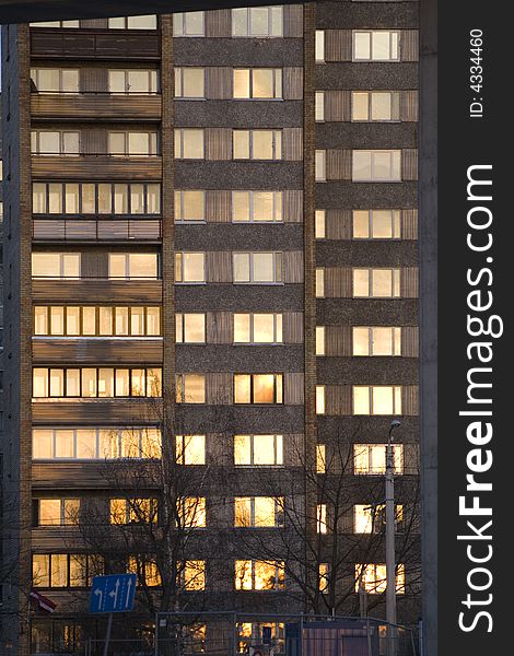 Many storey building with sunset reflection in windows. Many storey building with sunset reflection in windows