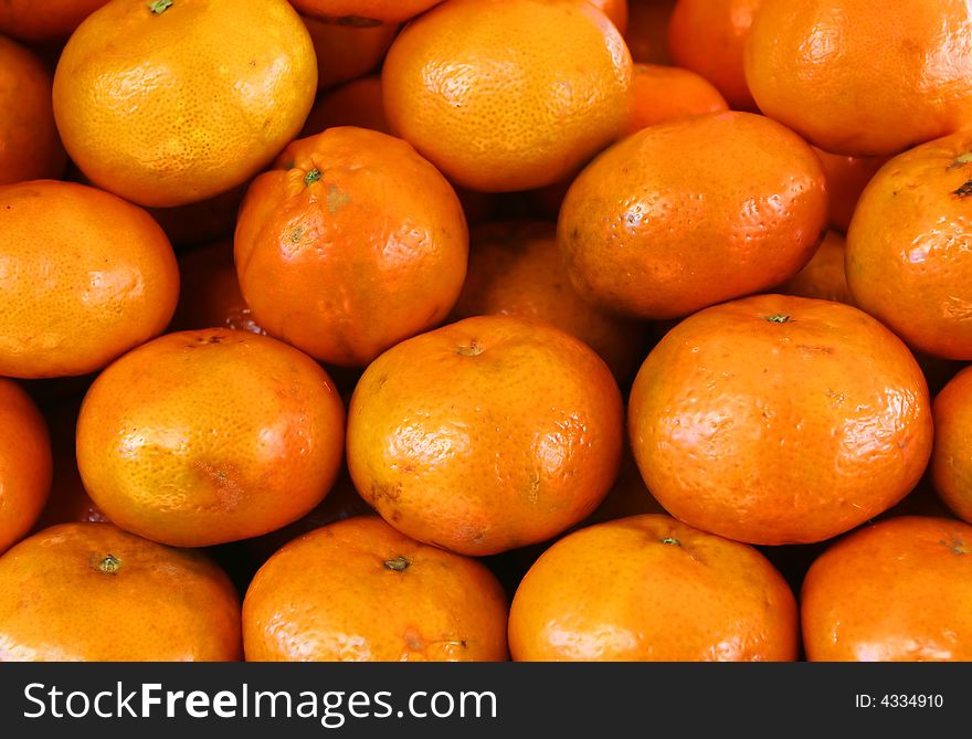Organic Oranges stacked high in a market