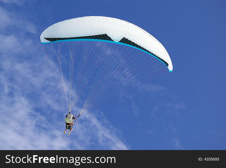 Para sail taking flight against a tranquil tropical blue sky background. Para sail taking flight against a tranquil tropical blue sky background