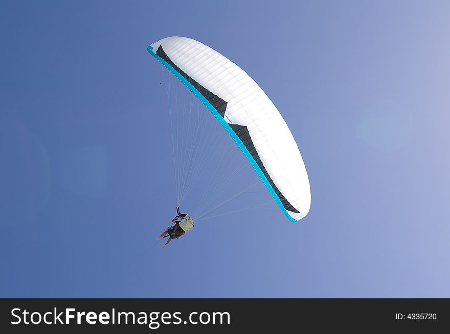 Para sail taking flight against a tranquil tropical blue sky background. Para sail taking flight against a tranquil tropical blue sky background