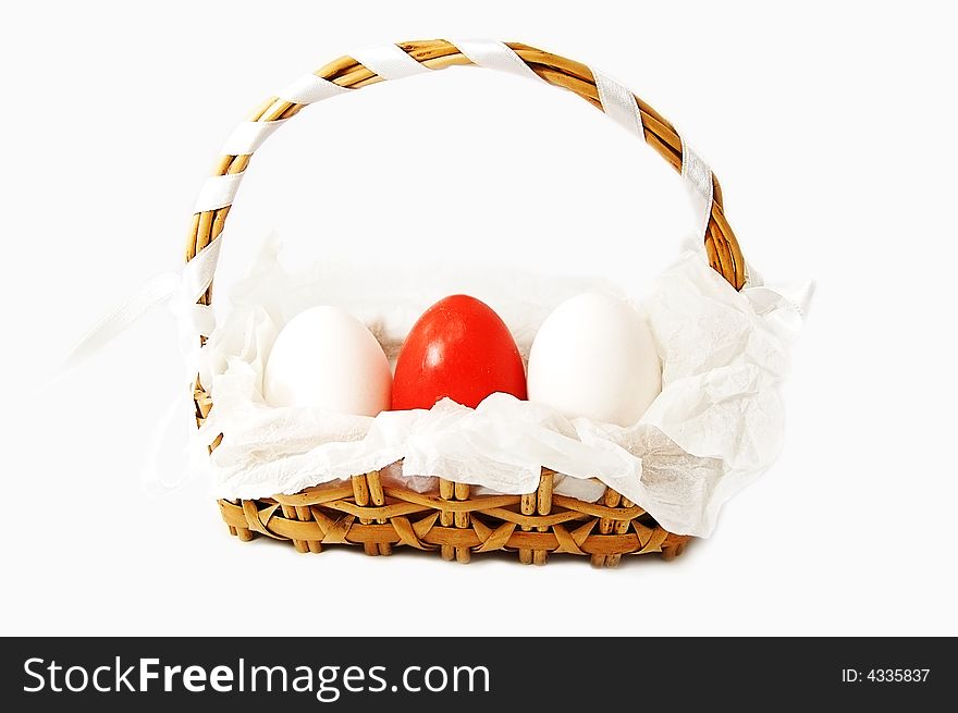 Basket with white and red eggs isolated on white. Basket with white and red eggs isolated on white