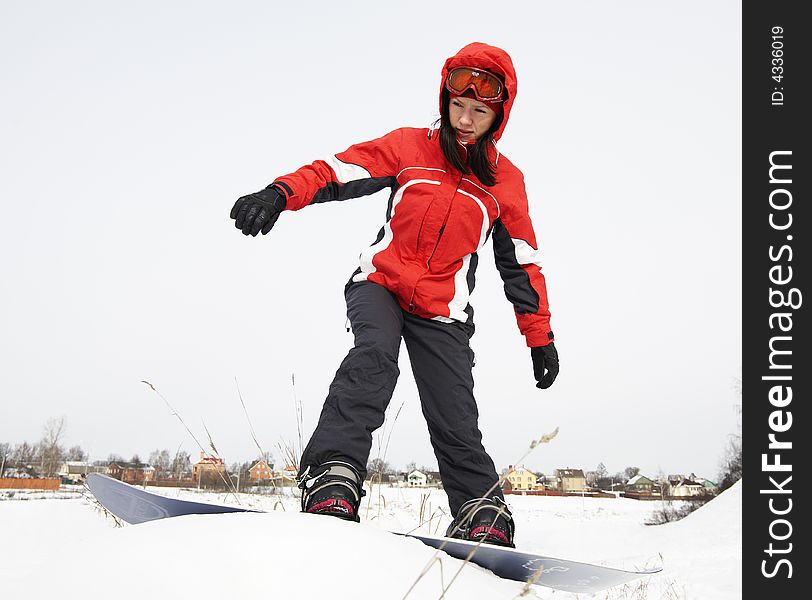 A lifestyle image of a young adult female (age 20-25) snowboarder. A lifestyle image of a young adult female (age 20-25) snowboarder.