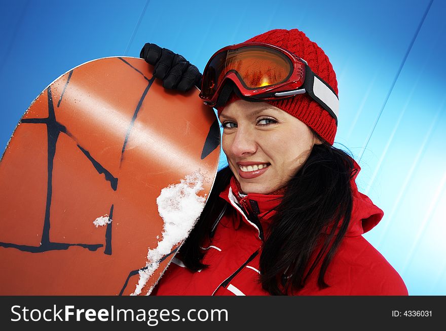 A lifestyle image of a young adult female (age 20-25) snowboarder. A lifestyle image of a young adult female (age 20-25) snowboarder.