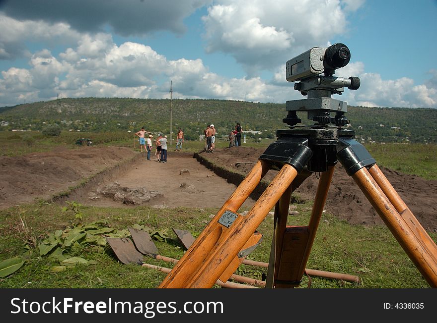 Group working at archaeological site with theodolite. Group working at archaeological site with theodolite