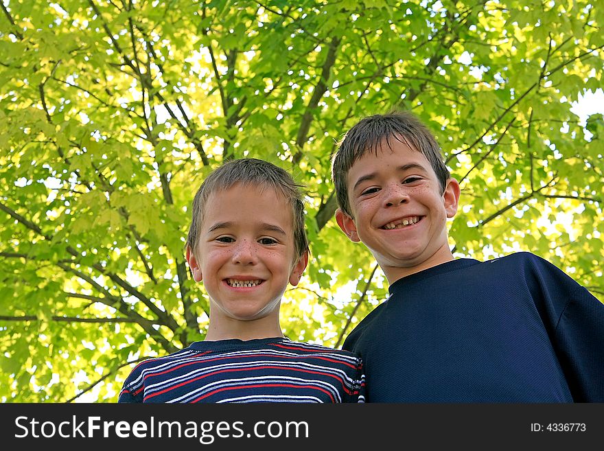 Brothers Standing in Front of a Tree