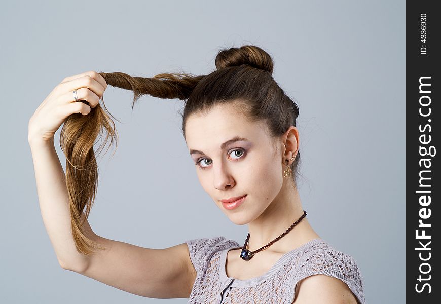 Girl with long twisted hair and a necklace on neck. Girl with long twisted hair and a necklace on neck