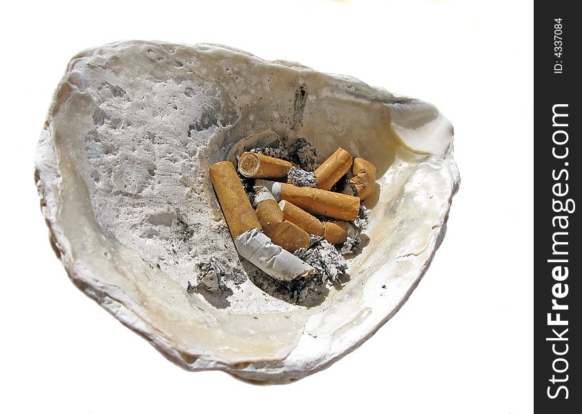 Cigarette butt in the shell ashtray, unhealthy life style concept