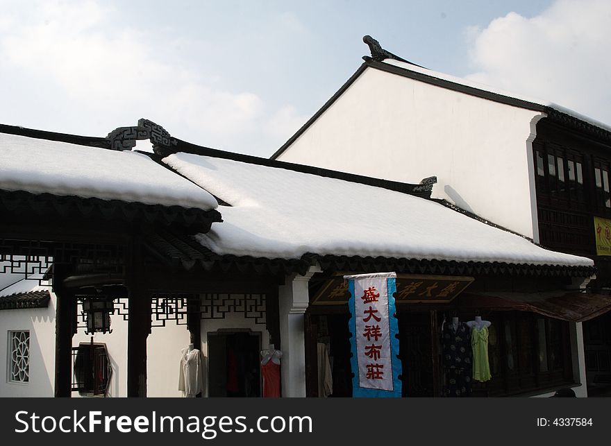 The beautiful and enjoyable snow scenery in the winter in the southern part of China. These sceneries are famous for their snow ,water, houses,and the blue sky.They are typical of the south in China.This picture is taken in the place of interestâ€œMooring by the Feng Bridge at nightâ€ in Suzhou ,China.