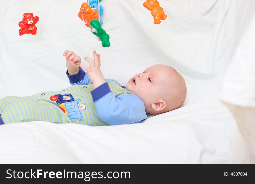 Baby playing with toys. Little boy touching the toys by finger. Baby playing with toys. Little boy touching the toys by finger