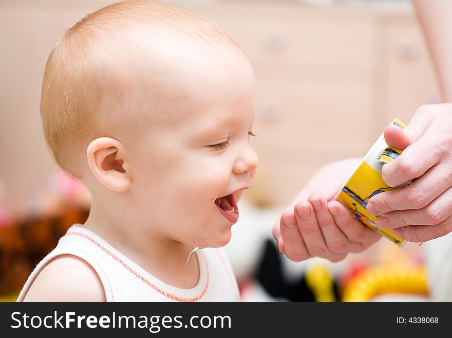 Mother get water to son. Baby enjoy playing with water drops