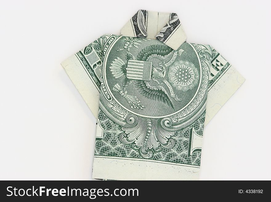 A US one dollar bill that has been folded into a shirt using origami on a white background. A US one dollar bill that has been folded into a shirt using origami on a white background.