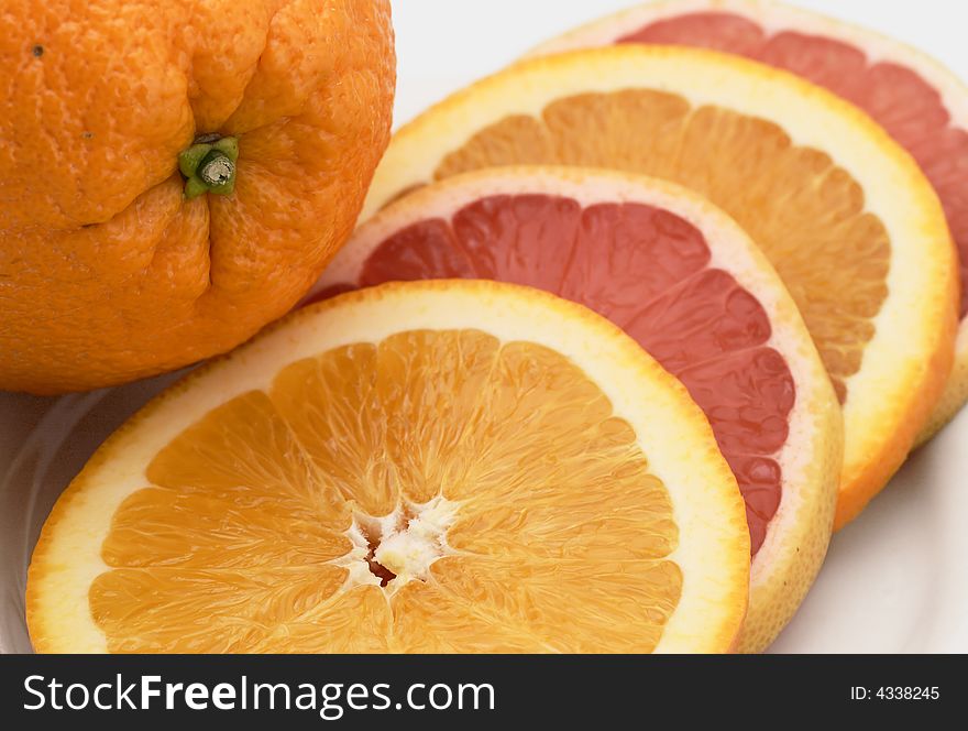 Sliced orange and pink grapefruit