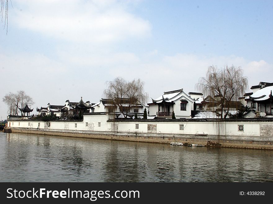 The beautiful and enjoyable snow scenery in the winter in the southern part of China. These sceneries are famous for their snow ,water, houses,and the blue sky.They are typical of the south in China.This picture is taken in the place of interest“Mooring by the Feng Bridge at night” in Suzhou ,China.