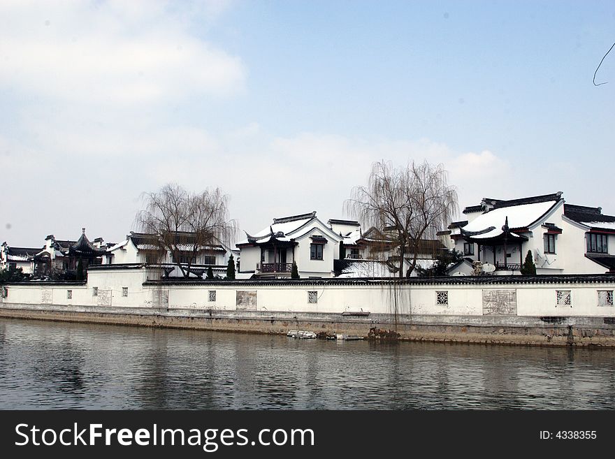 The beautiful and enjoyable snow scenery in the winter in the southern part of China. These sceneries are famous for their snow ,water, houses,and the blue sky.They are typical of the south in China.This picture is taken in the place of interest“Mooring by the Feng Bridge at night” in Suzhou ,China.