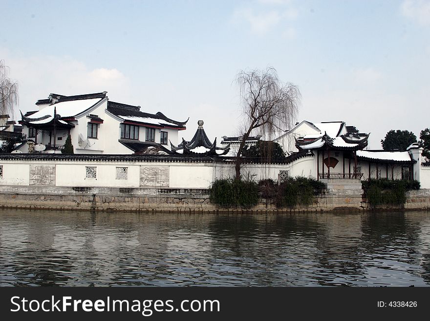 The beautiful and enjoyable snow scenery in the winter in the southern part of China. These sceneries are famous for their snow ,water, houses,and the blue sky.They are typical of the south in China.This picture is taken in the place of interestâ€œMooring by the Feng Bridge at nightâ€ in Suzhou ,China.