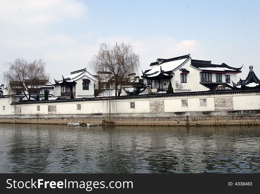 The beautiful and enjoyable snow scenery in the winter in the southern part of China. These sceneries are famous for their snow ,water, houses,and the blue sky.They are typical of the south in China.This picture is taken in the place of interestâ€œMooring by the Feng Bridge at nightâ€ in Suzhou ,China.