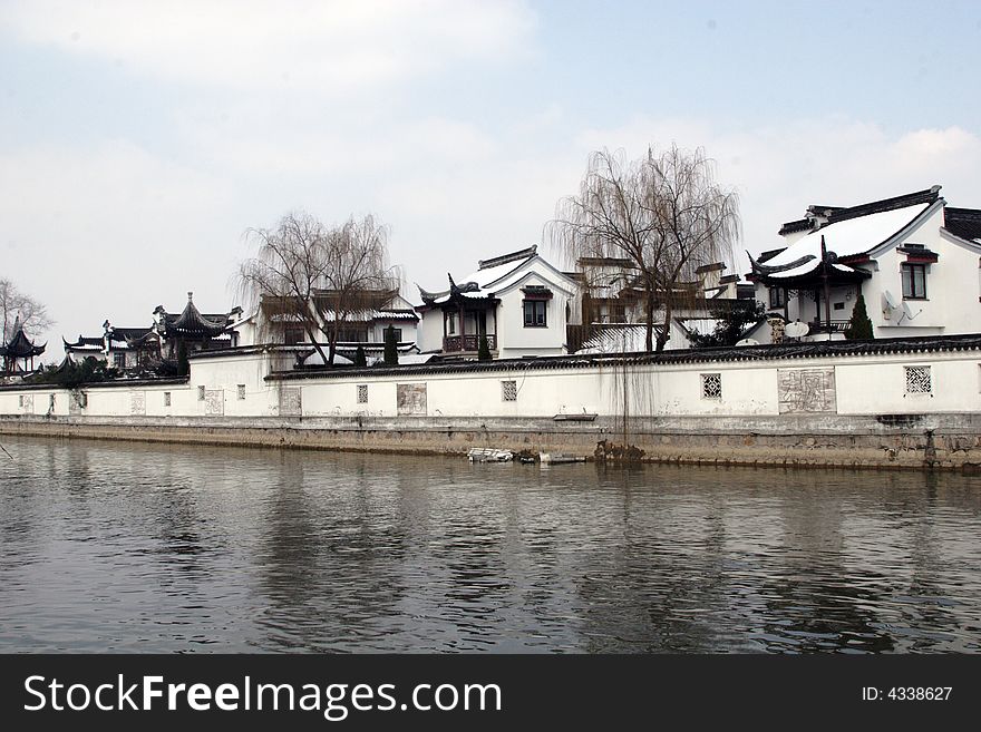 The beautiful and enjoyable snow scenery in the winter in the southern part of China. These sceneries are famous for their snow ,water, houses,and the blue sky.They are typical of the south in China.This picture is taken in the place of interest“Mooring by the Feng Bridge at night” in Suzhou ,China.