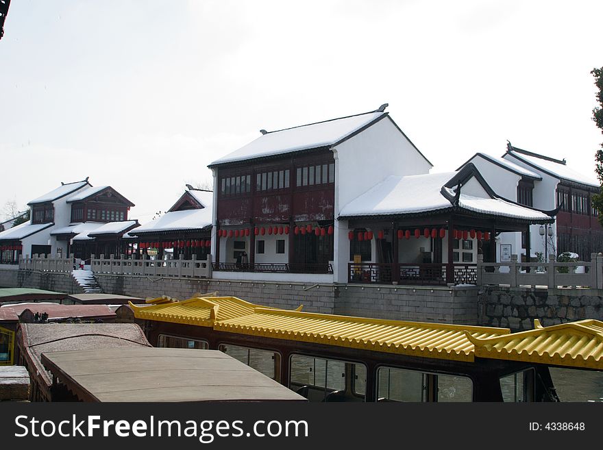 The beautiful and enjoyable snow scenery in the winter in the southern part of China. These sceneries are famous for their snow ,water, houses,and the blue sky.They are typical of the south in China.This picture is taken in the place of interest“Mooring by the Feng Bridge at night” in Suzhou ,China.