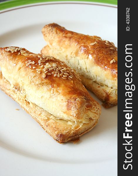 2 chinese style puff pastries on a white plate. 2 chinese style puff pastries on a white plate