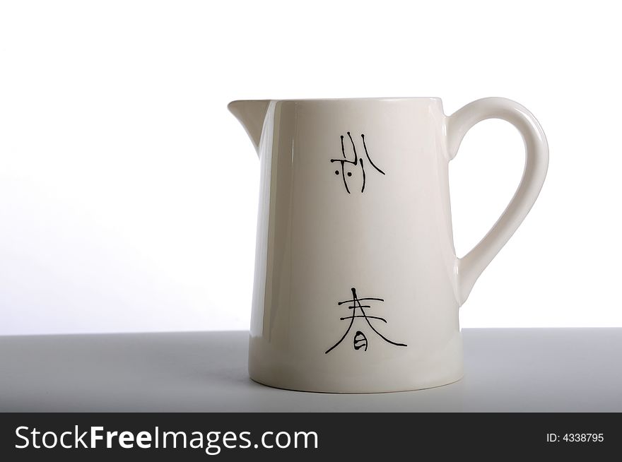 Asian ceramic pitcher with Japanese calligraphy.