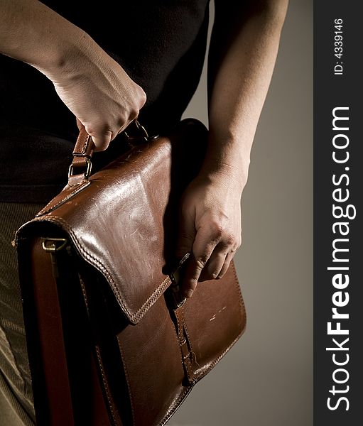 Hand opening elegant brown briefcase. Hand opening elegant brown briefcase