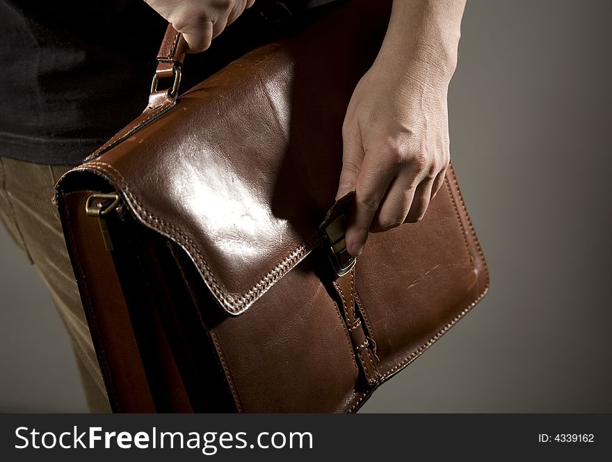 Hand opening elegant brown briefcase. Hand opening elegant brown briefcase