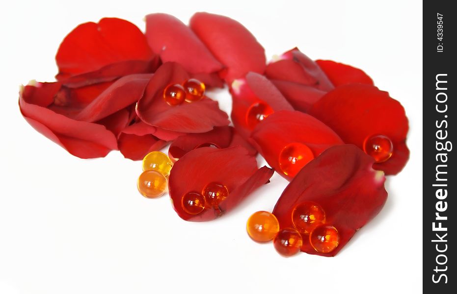 Red rose petals and pearls isolated on white