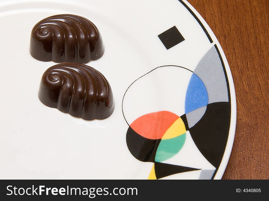 Chocolate candies on white plate