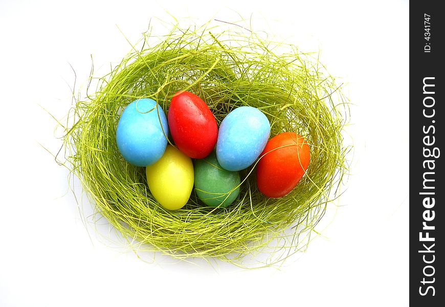 Nest with colorful easter eggs on white. Nest with colorful easter eggs on white