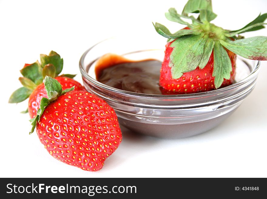 Strawberries and chocolate dipping sauce isolated on a white background. Strawberries and chocolate dipping sauce isolated on a white background.