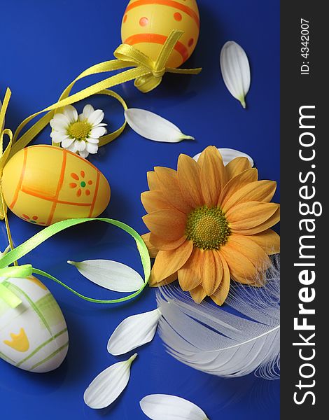 Easter eggs with flower on blue background.
