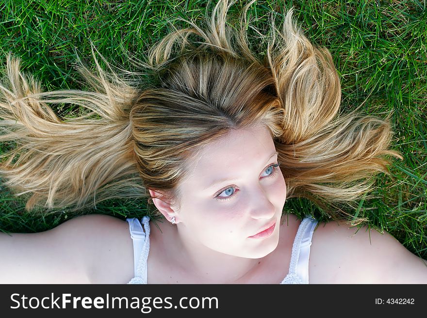 Woman Laying In The Grass