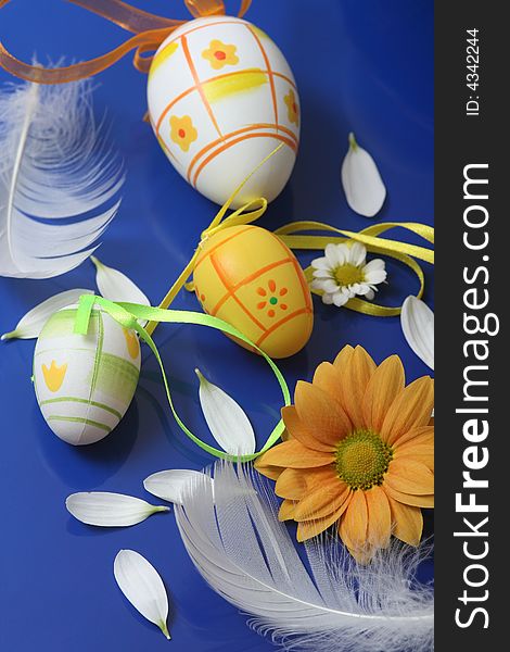 Easter eggs with flower on blue background.