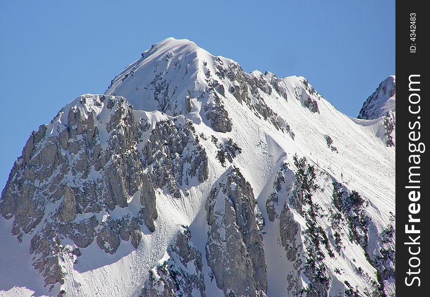 Winter in the Alps, beautiful mountain peak covered in snow on a beautiful sunny day. Winter in the Alps, beautiful mountain peak covered in snow on a beautiful sunny day