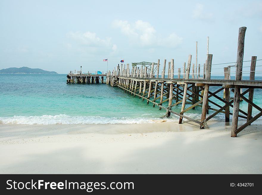 Wooden jetty on beautiful clean beach