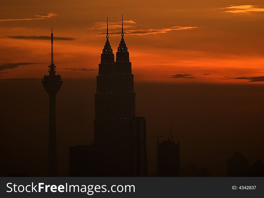 Kuala Lumpur City Skyline at sunset showing the PETRONAS Twin Towers as well as Kuala Lumpur Tower. Kuala Lumpur City Skyline at sunset showing the PETRONAS Twin Towers as well as Kuala Lumpur Tower