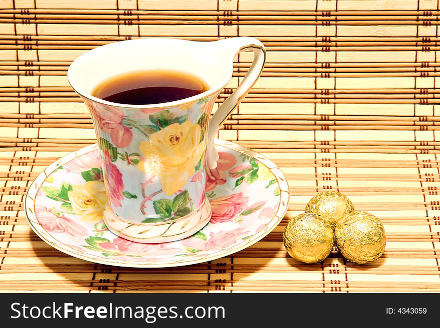 Cup with tea and sweets on a wooden surface. Cup with tea and sweets on a wooden surface