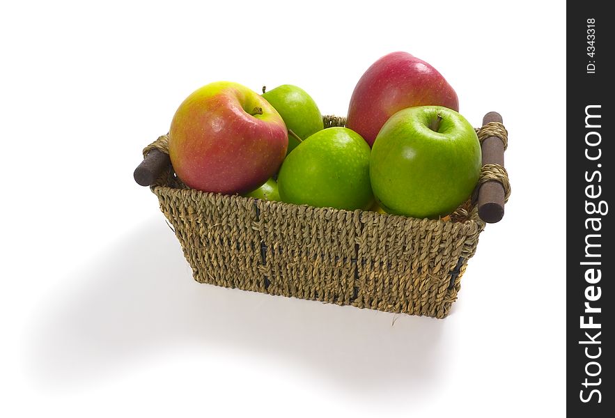 Isolated straw basket filled with apples. Isolated straw basket filled with apples