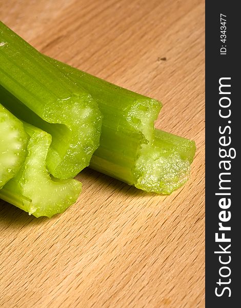 Fresh green celery on a wood cutting board