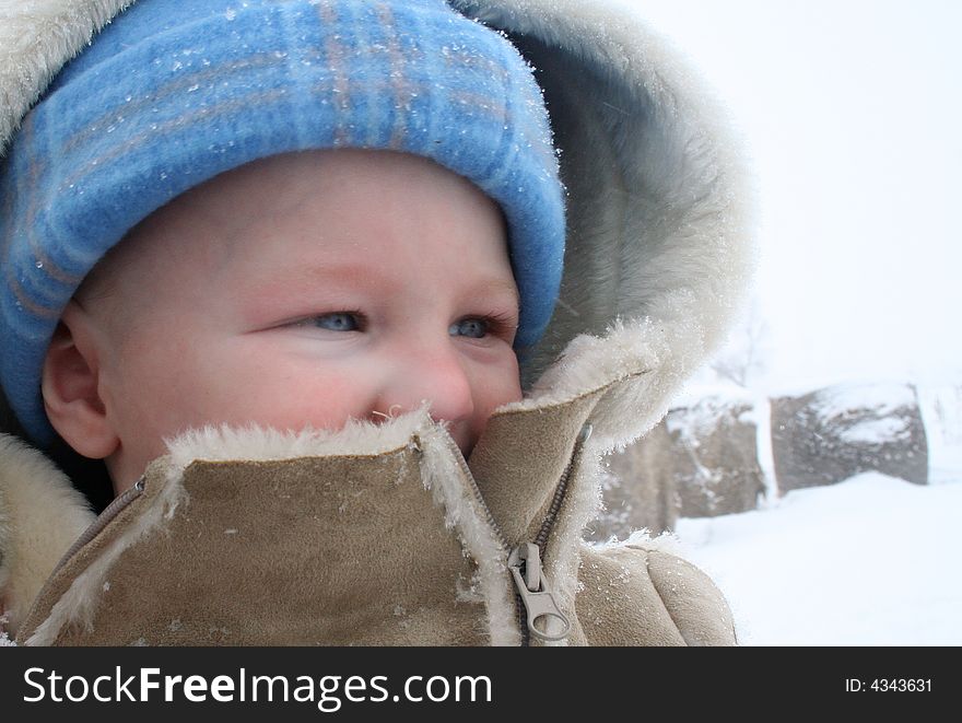 Baby Bundled in Leather and Fur out in a winter blizzard. Baby Bundled in Leather and Fur out in a winter blizzard