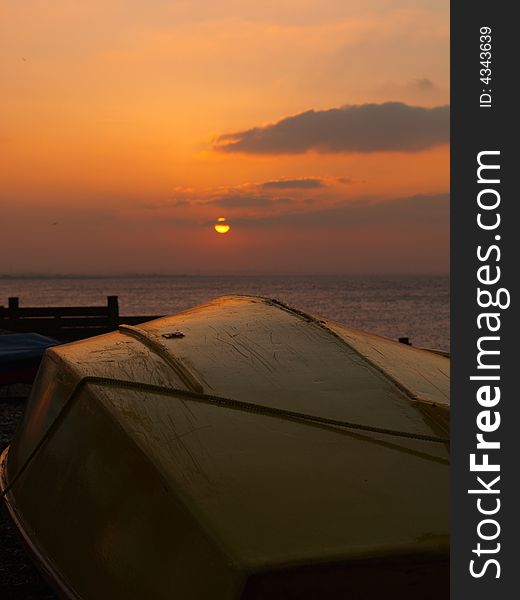 Sunset and sailing boat on Whitstable Beach. Sunset and sailing boat on Whitstable Beach